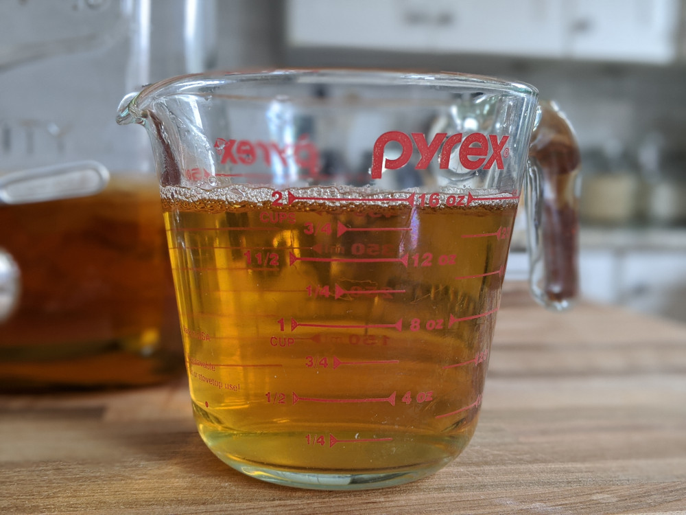 A Pyrex measuring cup with 2 cups of kombucha starter.