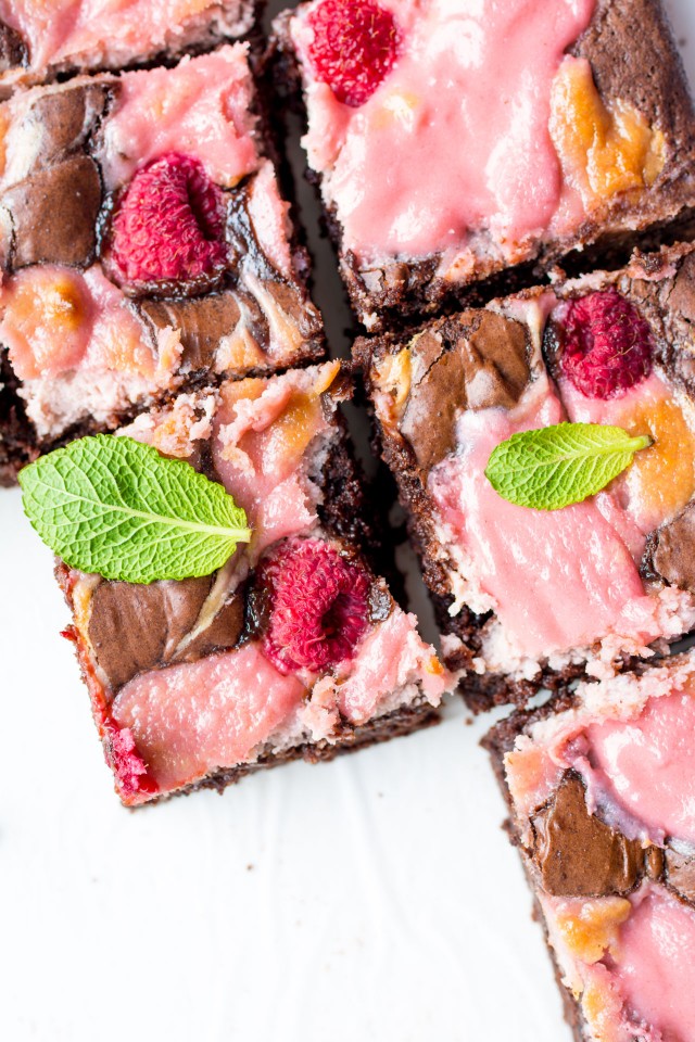 close up image of rapsberry cheese cake brownies cut in cubes